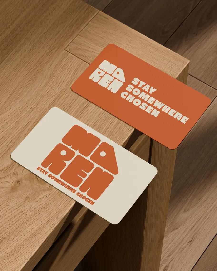 An orange Maren key card reading Stay Somewhere Chosen, resting on a wooden table