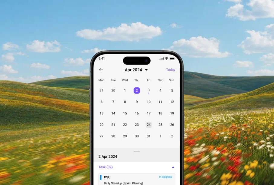 Ezy app on a phone showing an April 2024 calendar, set against a meadow of wildflowers