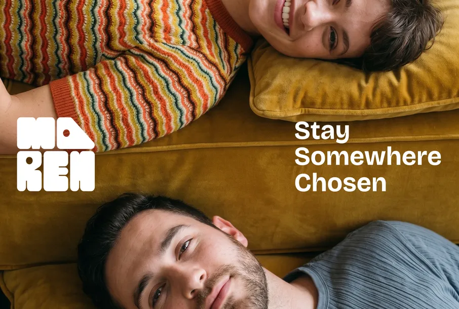 Maren campaign: two people lying head-to-head on a mustard sofa beside the line Stay Somewhere Chosen